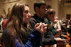 Woman prays rosary at pro-life vigil